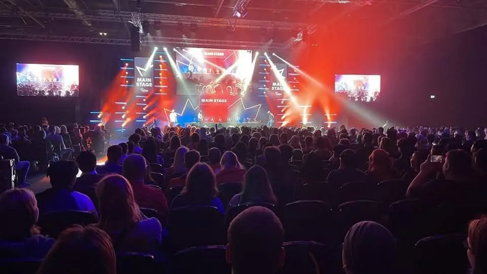 A large audience gathered at a live main-stage event